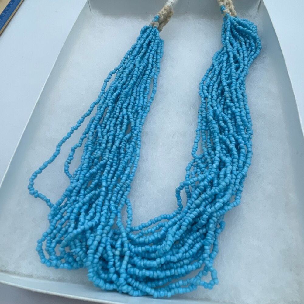 Artisan made multi strand seed bead light blue necklace .